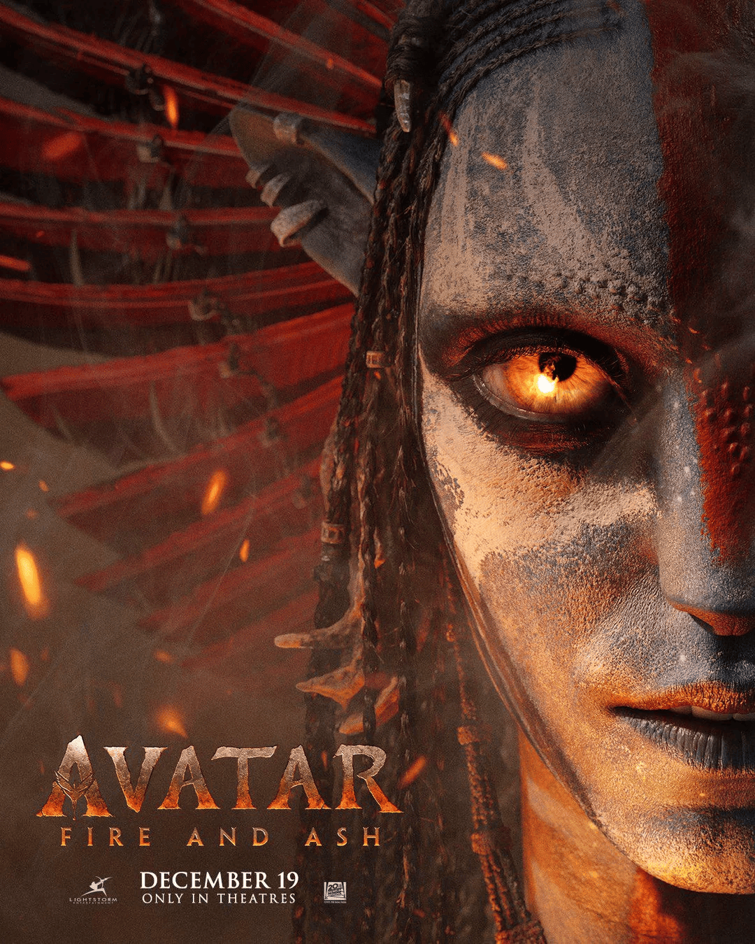 "Official Avatar 3: Fire and Ash poster showing a Na’vi warrior with an intense glowing eye and ash-covered face, symbolizing the fiery new storyline."